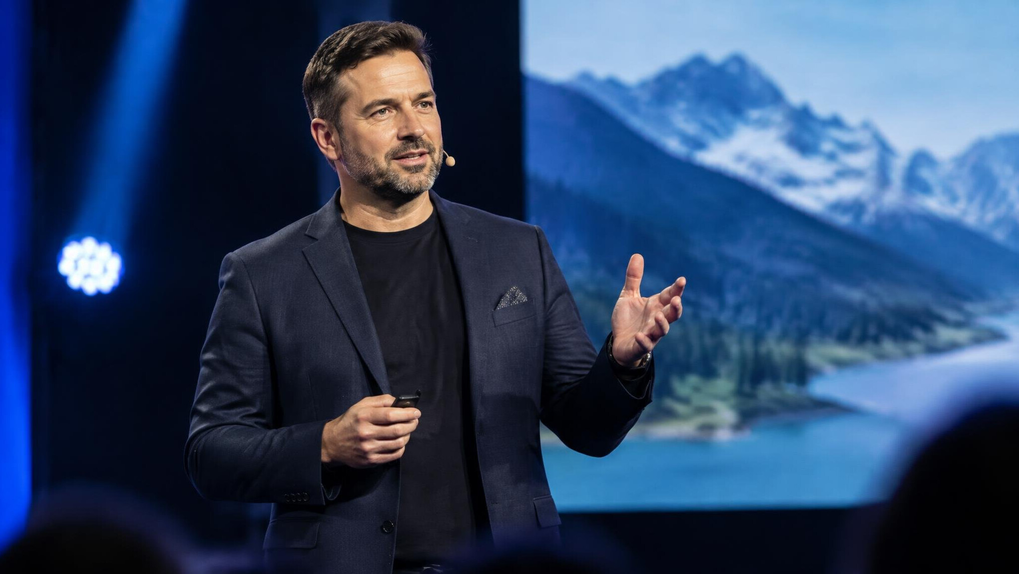 Speaker giving a keynote presentation on a conference stage